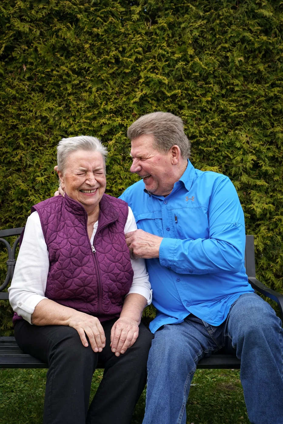 Two adults laughing together outdoors